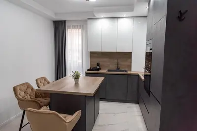 a kitchen with a wooden table and two chairs at A-Dent luxury apartments & Dental Clinic in Gotse Delchev