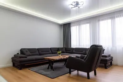 a living room with a couch and a table and chairs at A-Dent luxury apartments & Dental Clinic in Gotse Delchev