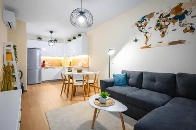 a living room with a couch and a table at Bright and Cosy 1BD Flat - Perfect for Business Trip by Flat Mаnager in Sofia