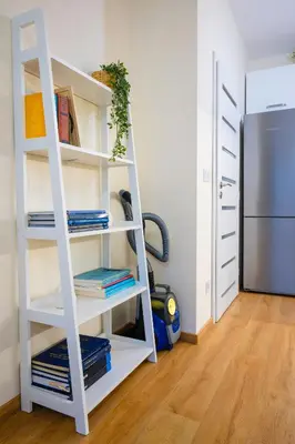 a white book shelf in a room with a refrigerator at Bright and Cosy 1BD Flat - Perfect for Business Trip by Flat Mаnager in Sofia
