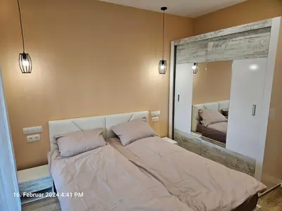a bedroom with a large mirror above a bed at Dilyanka in Pernik