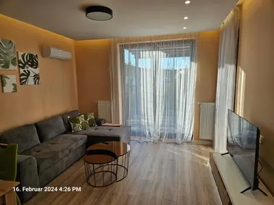 a living room with a couch and a table at Dilyanka in Pernik