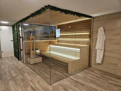 a room with a sauna with a glass wall at Villa Geronimo in Bansko