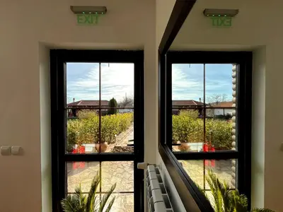 two windows in a house looking out at a vineyard at Entheos in Vŭrben