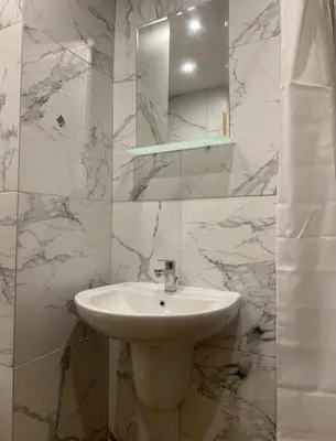 a white bathroom with a sink and a mirror at Borovets gardens Studio A12 in Borovets