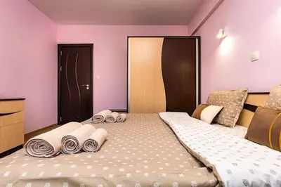 a bedroom with a large bed with towels on it at Spacious Central Apt by Stefanie / close to MU in Plovdiv