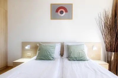 a bedroom with a bed with white sheets and pillows at Mountain Escape & View & Relax in Bansko