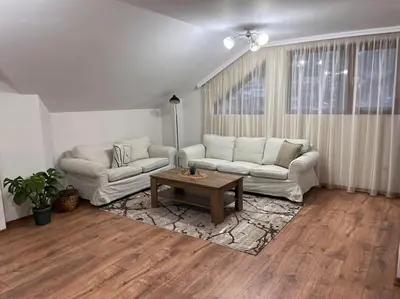 a living room with two couches and a coffee table at Двуспален апартамент в к-с Пирин Палас in Bansko