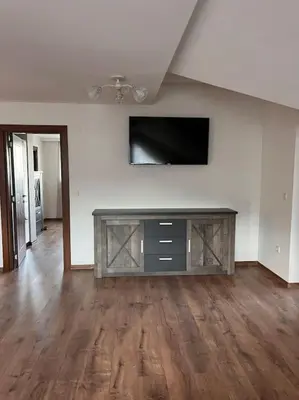 a living room with a flat screen tv on a wall at Двуспален апартамент в к-с Пирин Палас in Bansko