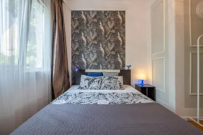 a bedroom with a large bed with a wall at Classy apartment in Sofia