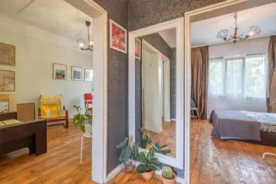 a room with a bed and a mirror at Classy apartment in Sofia