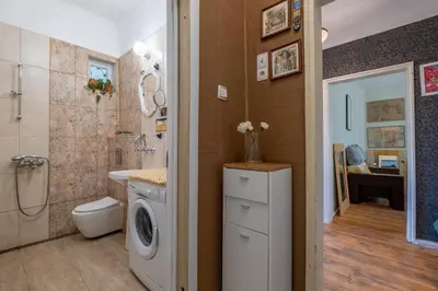a bathroom with a washing machine next to a shower at Classy apartment in Sofia
