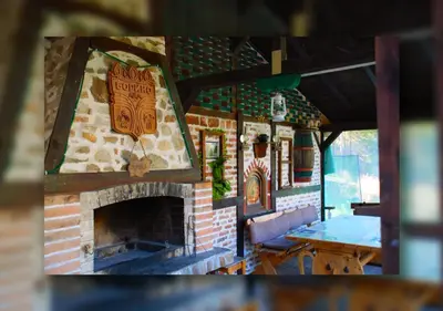 a model of a house with a brick fireplace at ВИЛА ПЕРИКА-Vila PERIKA in Borino