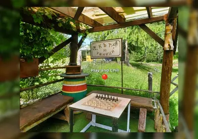 a table and bench in a pavilion with a sign at ВИЛА ПЕРИКА-Vila PERIKA in Borino