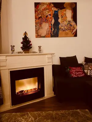 a living room with a fireplace with a christmas tree at 705 in The Stream Resort in Pamporovo