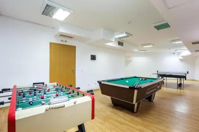 a room with two pool tables in a room at 705 in The Stream Resort in Pamporovo