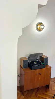 a room with a table with a lamp on it at Bohemian Central Apartment Sofia in Sofia