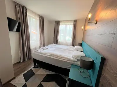 a bedroom with a large bed and a table at Private Villa in Ruskovets in Dobrinishte