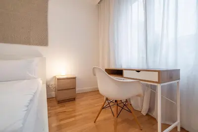 a bedroom with a desk and a chair next to a bed at The Griffin in Sofia