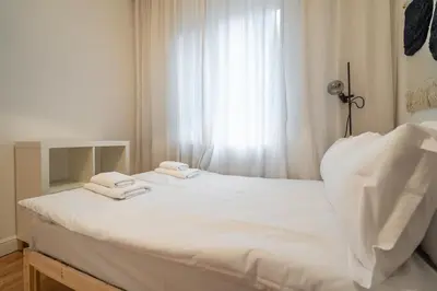a bedroom with a white bed with towels on it at The Griffin in Sofia