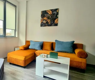 a living room with a couch and a table at Flower home 11 in Sofia