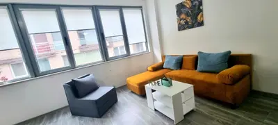 a living room with a couch and a chair at Flower home 11 in Sofia