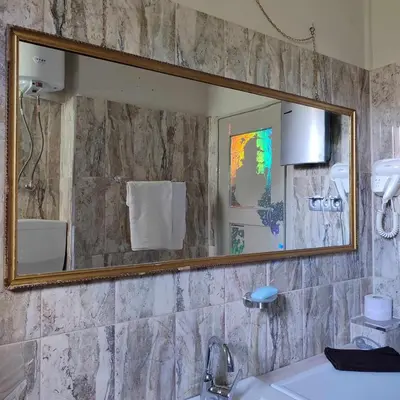 a bathroom with a mirror and a sink at INSTA Haus in Plovdiv
