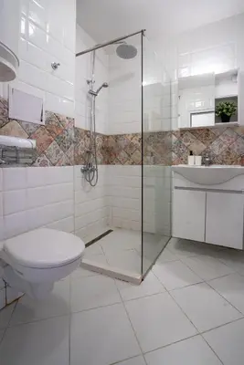 a bathroom with a toilet and a shower and a sink at Sunny 1BDR Apartment near Center in Sofia