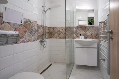 a bathroom with a shower and a toilet and a sink at Sunny 1BDR Apartment near Center in Sofia