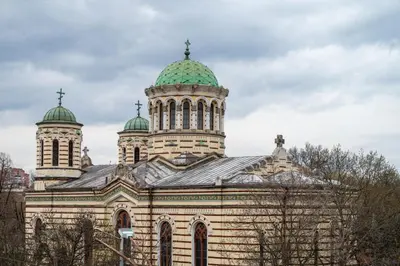 a large building with two domes on top of it at Sunny 1BDR Apartment near Center in Sofia