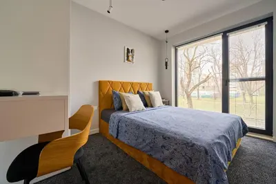 a bedroom with a bed and a desk and a window at Scandinavian Stay - Awarded Bldg - Downtown in Sofia