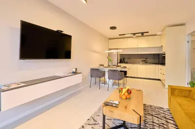 a living room with a large flat screen tv on the wall at Scandinavian Stay - Awarded Bldg - Downtown in Sofia