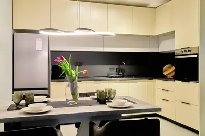 a kitchen with a table with a vase of flowers on it at Scandinavian Stay - Awarded Bldg - Downtown in Sofia