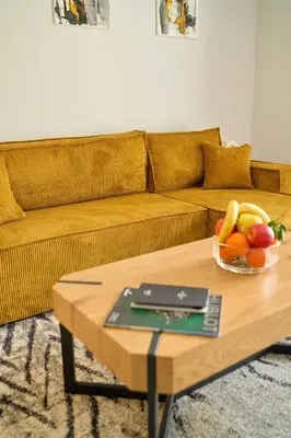 a living room with a table with a bowl of fruit at Scandinavian Stay - Awarded Bldg - Downtown in Sofia