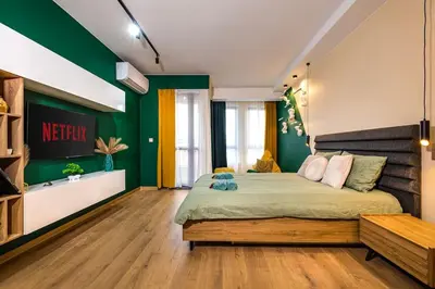 a bedroom with a large bed and green walls at Green Hills Plovdiv close to Medical University in Plovdiv