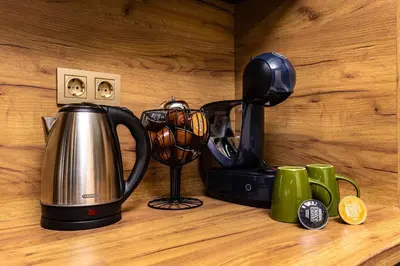 a tea kettle and a blender on a wooden counter at Green Hills Plovdiv close to Medical University in Plovdiv