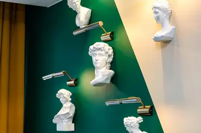 a group of busts on a wall in a museum at Green Hills Plovdiv close to Medical University in Plovdiv