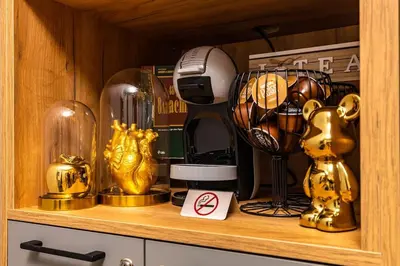 a wooden cabinet with trophies on a shelf at Apollo Apartment close to Medical University in Plovdiv