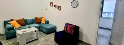 a living room with a couch and a chair at Flower home 10 in Sofia