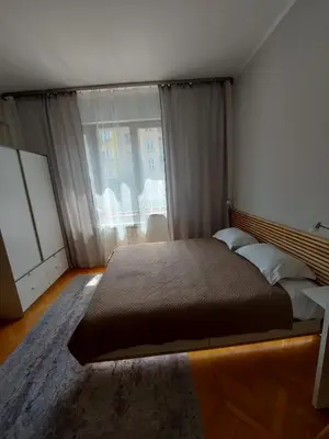a bedroom with a large bed and a large window at Studio 72 in Sofia