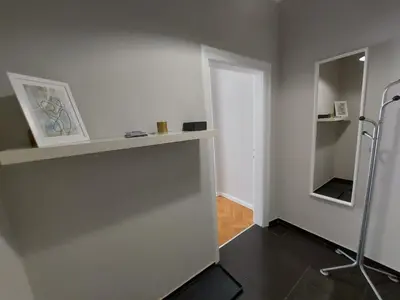 a room with a wall with a shelf and a mirror at Studio 72 in Sofia