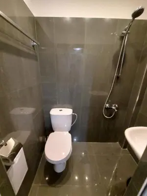 a bathroom with a toilet and a shower and a sink at Studio 72 in Sofia