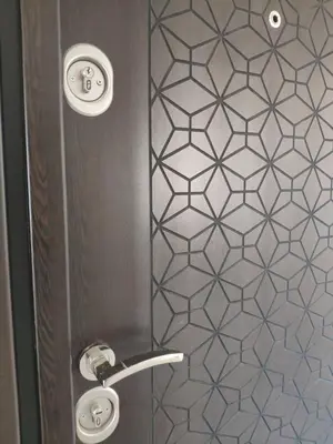 a shower with a metal door with a pattern on the wall at Central, brand new apart with parking in Blagoevgrad