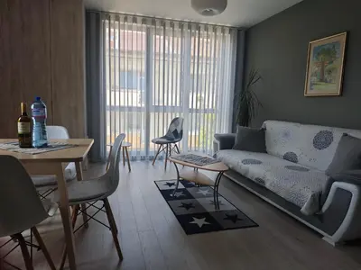 a living room with a couch and a table at Central, brand new apart with parking in Blagoevgrad