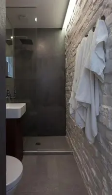 a bathroom with a sink and a shower with towels at Gorgeous apartment in the perfect area in Sofia