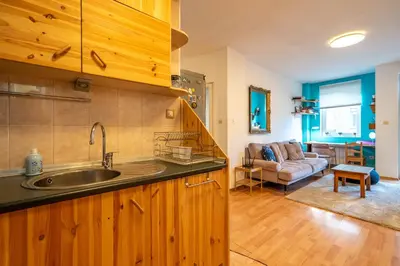 a kitchen with a sink and a living room at 1 Bedroom Natural Condo in Sofia