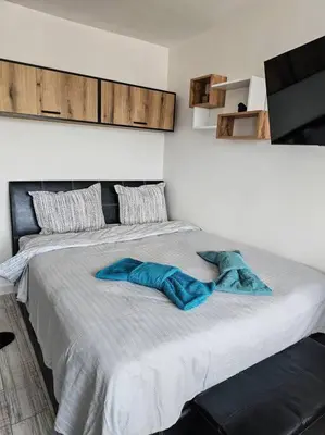 a large bed with two blue pillows on it at Boutique Studio B37 in Borovets