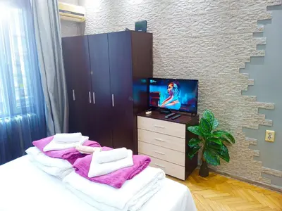 a bedroom with a tv and a bed with towels at 