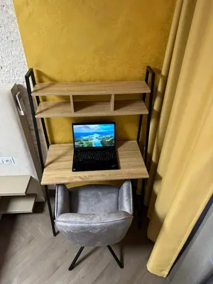 a laptop computer sitting on a desk in a chair at Regatta Park 2BR Exclusive Suite Parking Included in Plovdiv