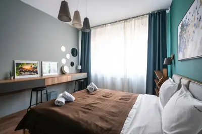 a bedroom with a bed with towels on it at Lux Flat next to Park with working space by Flat Mаnager in Sofia